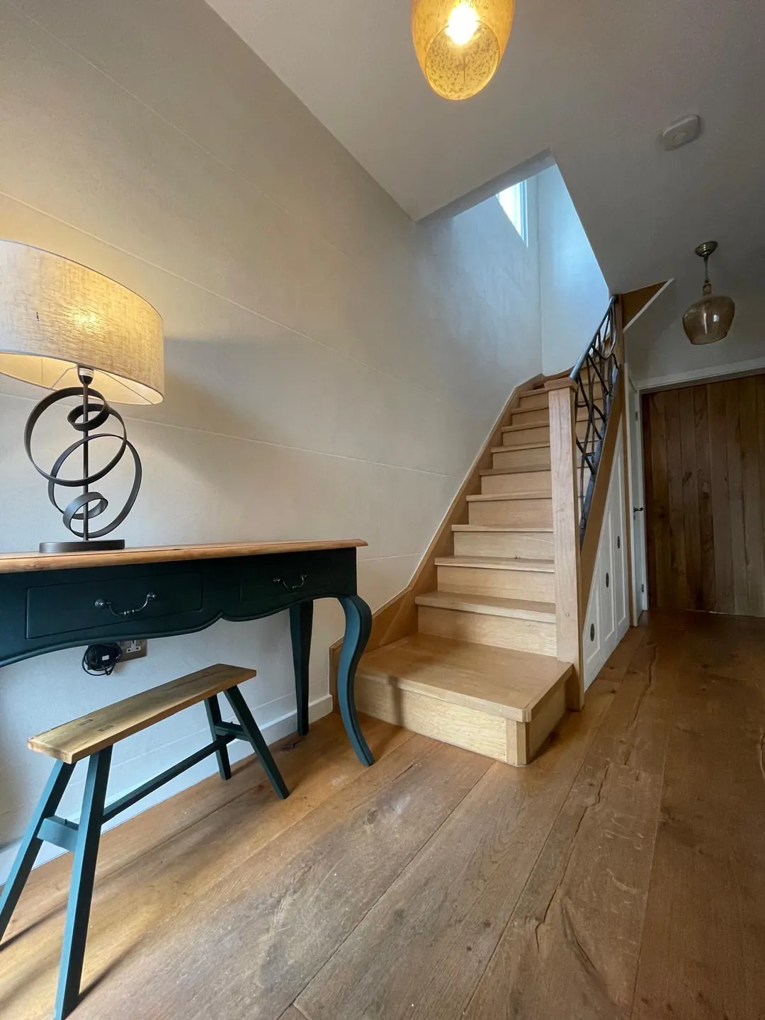 Islington entrance hall with warm polished plaster walls and a softly reflective mineral finish opening view