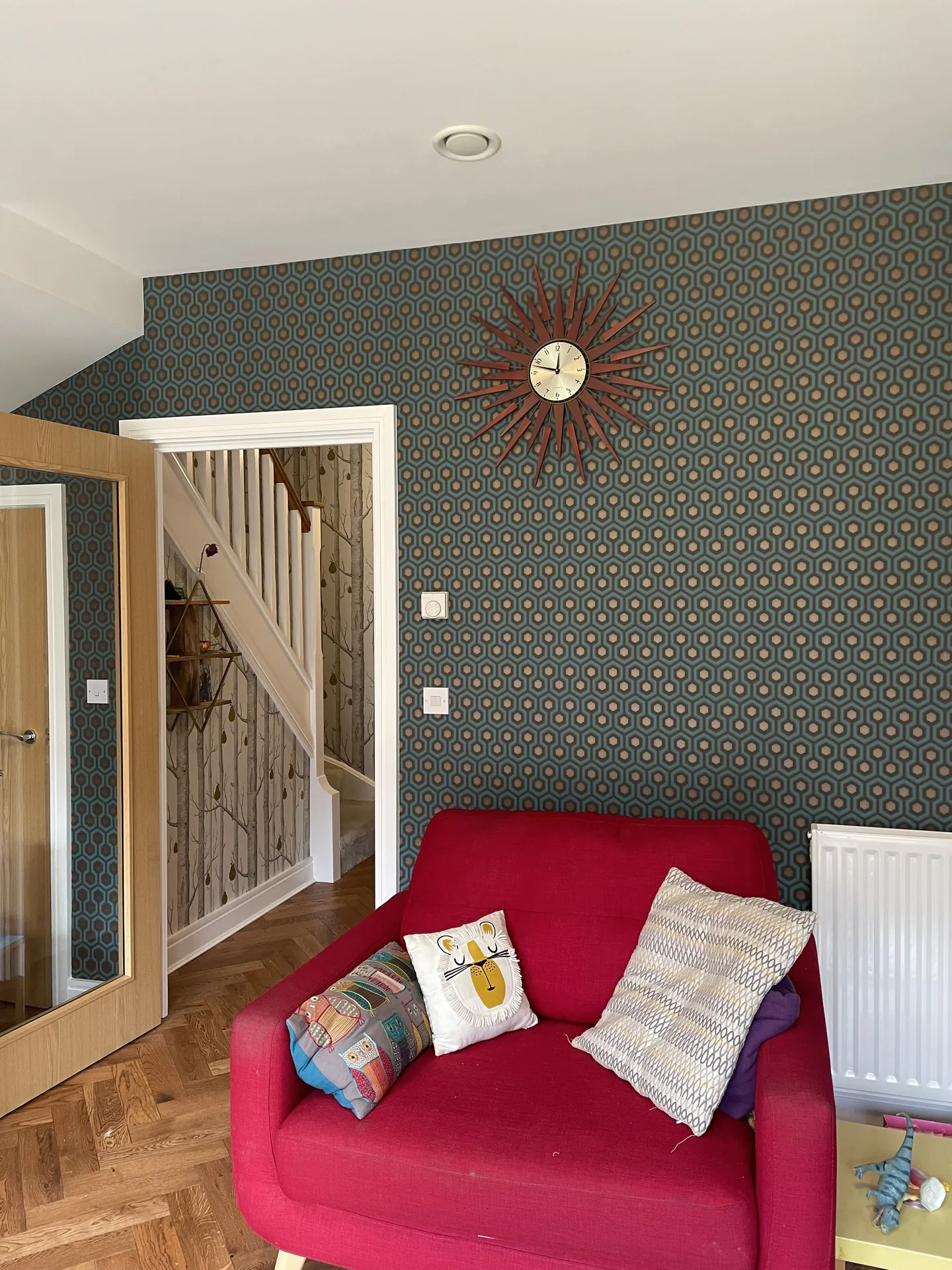 Muswell Hill entrance stairwell hung with bold Hicks Hexagon wallpaper across walls and stair rise finished room view