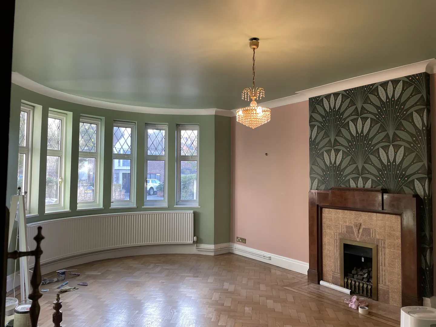 Highgate reception room with sage-painted walls, botanical wallpaper and original period detailing opening view